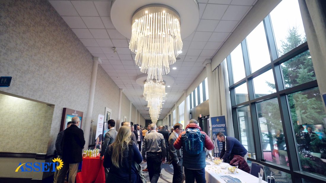 Attendees and vendor tables in the conference hallway